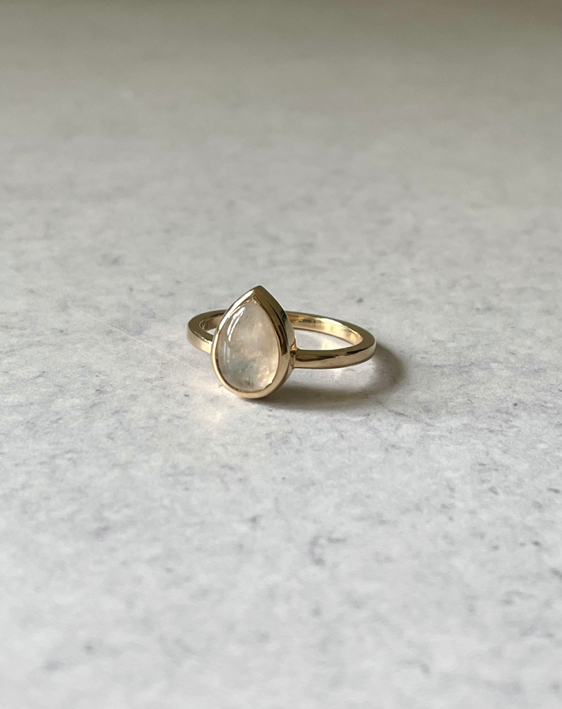 pear-shaped rainbow moonstone set in solid 14k gold