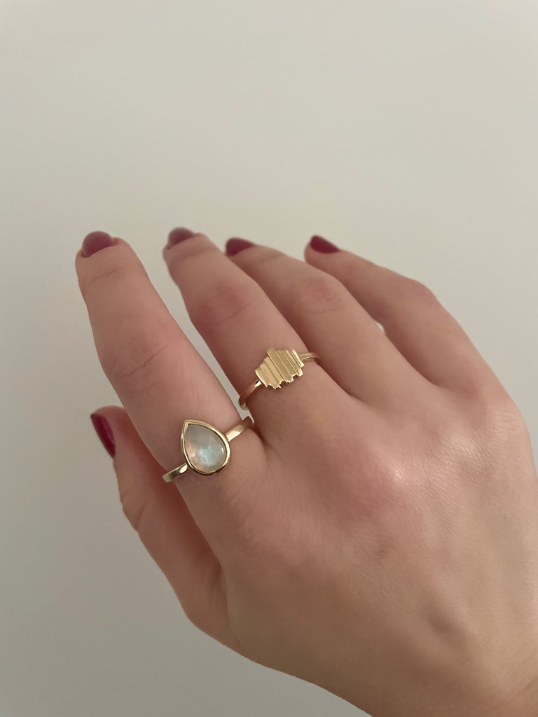 pear-shaped rainbow moonstone set in solid 14k gold ring paired with the solid 14k gold art deco ring